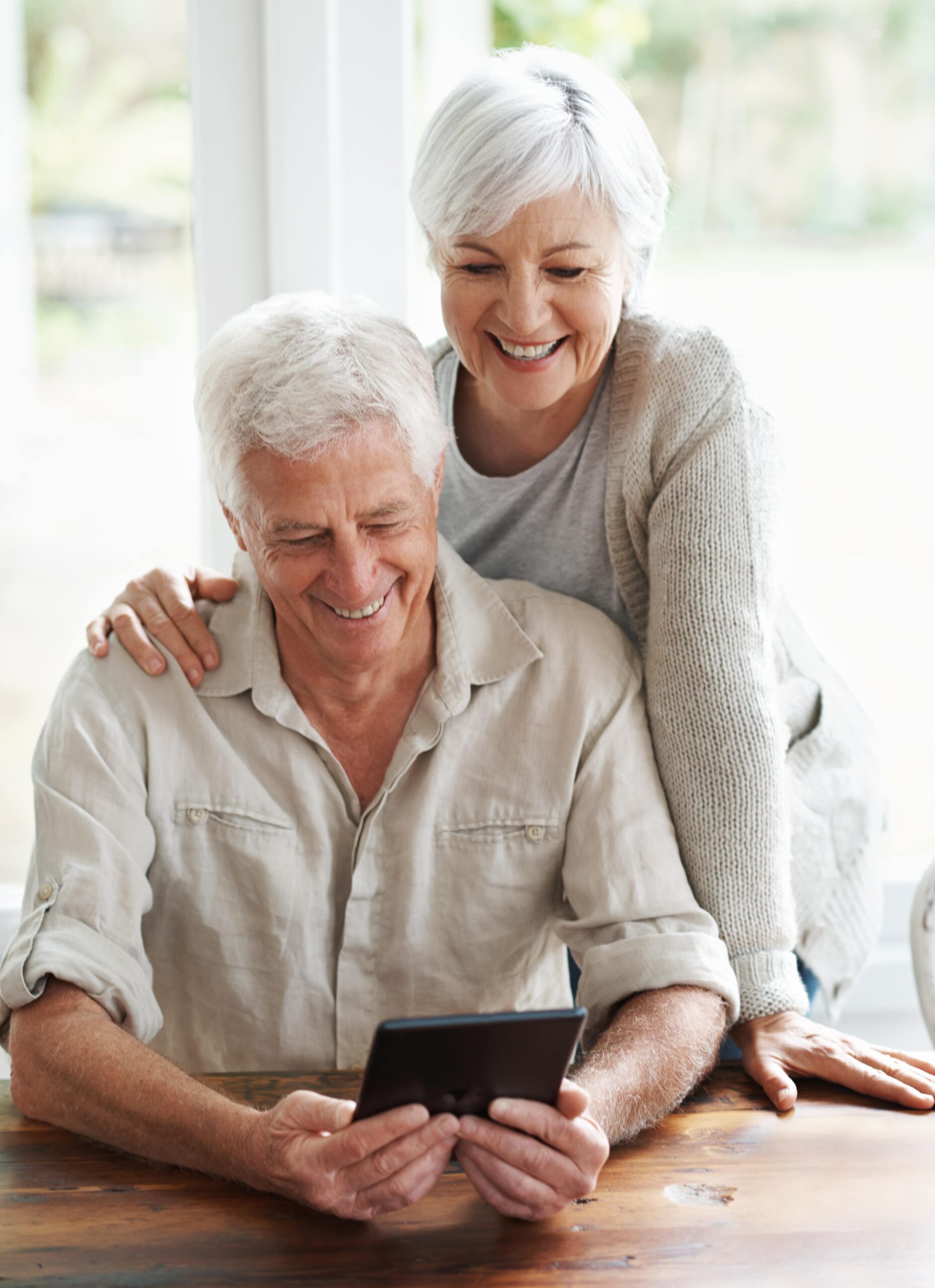 a-senior-couple-examining-a-digital-tablet