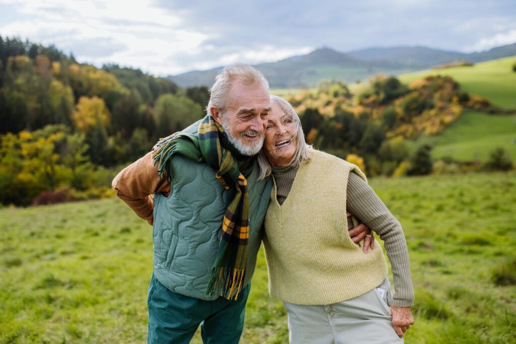 happy-senior-couple-walking-in-autumn-meadow-2022-10-25-21-40-52-utc-min